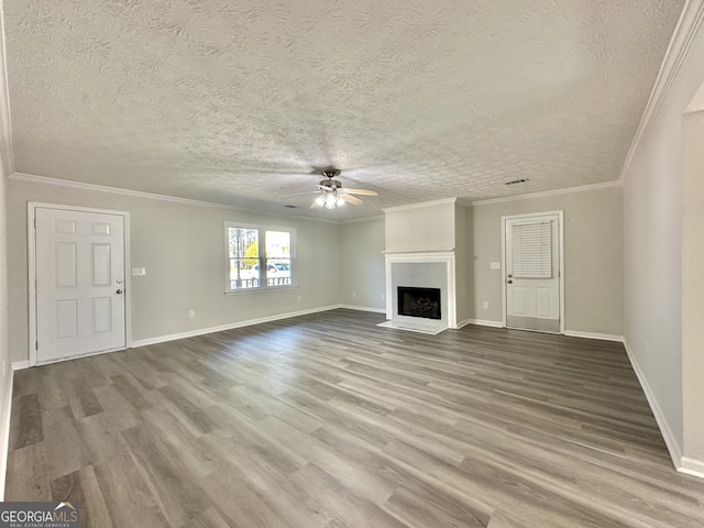 unfurnished living room featuring wood-type flooring, ornamental molding, a textured ceiling, and ceiling fan