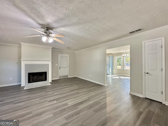 unfurnished living room with ceiling fan with notable chandelier, dark wood-type flooring, ornamental molding, and a textured ceiling