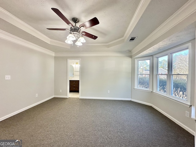 carpeted empty room featuring ceiling fan, ornamental molding, a raised ceiling, and a textured ceiling