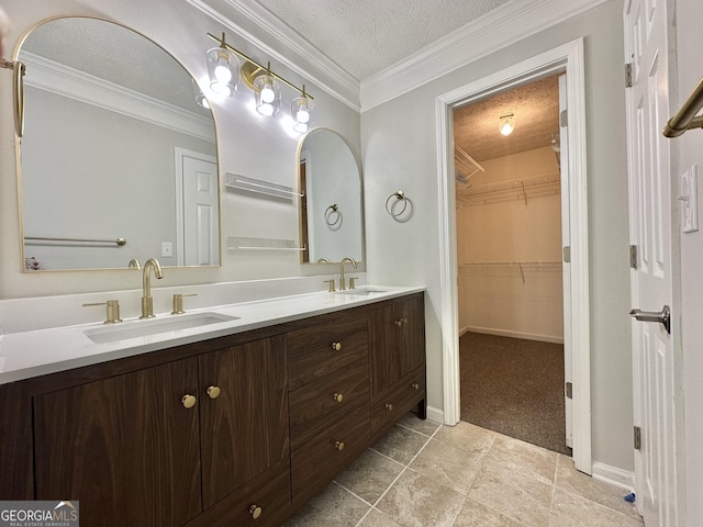 bathroom with vanity, ornamental molding, and a textured ceiling