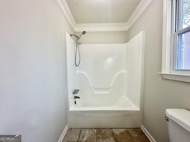 bathroom with a textured ceiling, shower / tub combination, ornamental molding, and toilet