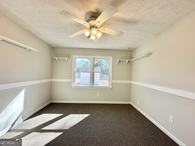 empty room featuring a textured ceiling, ceiling fan, and carpet flooring