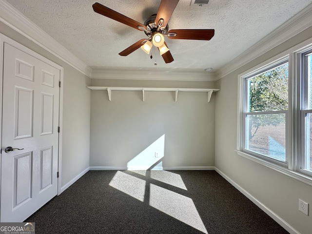 carpeted empty room featuring crown molding and a textured ceiling