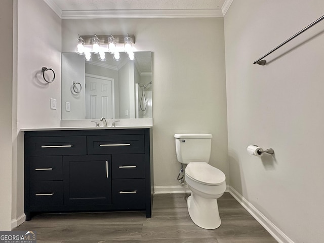 bathroom with crown molding, wood-type flooring, vanity, and toilet