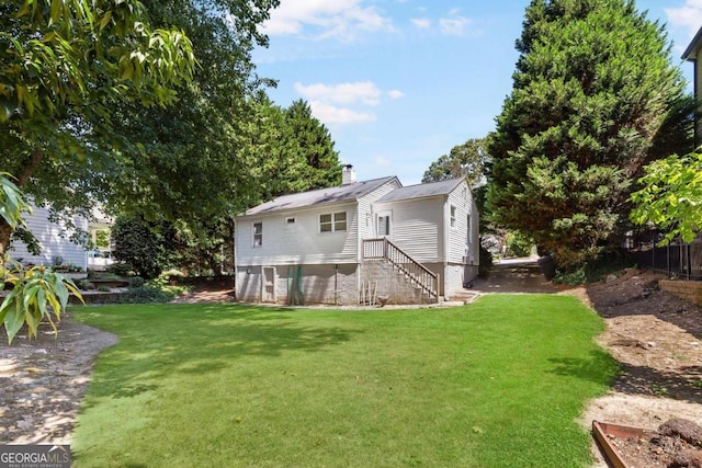 back of house featuring a yard