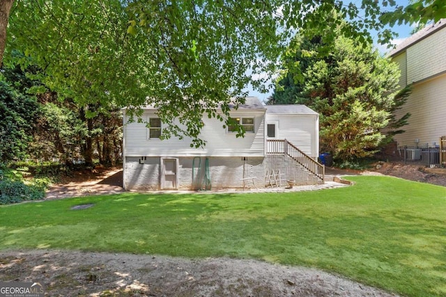 back of house featuring a lawn