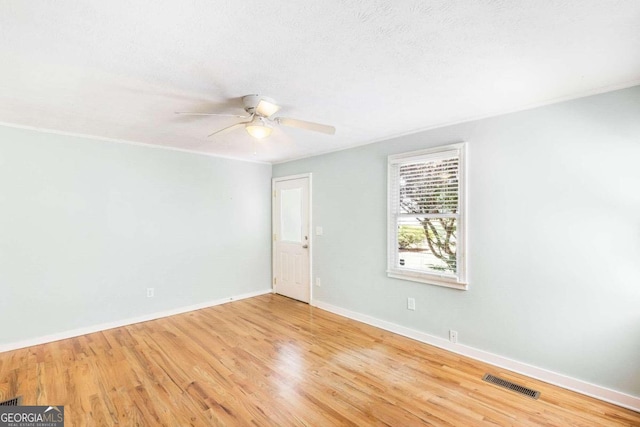 spare room featuring ceiling fan and light hardwood / wood-style floors