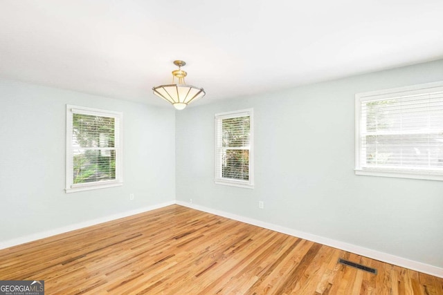 empty room with hardwood / wood-style flooring