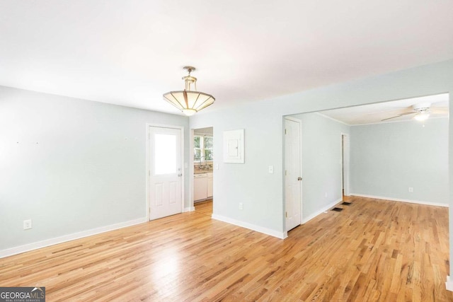 unfurnished room featuring ceiling fan and light hardwood / wood-style flooring