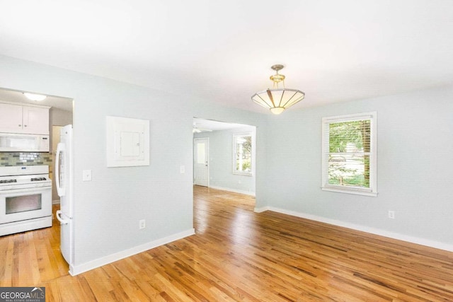 interior space with ceiling fan and light hardwood / wood-style flooring