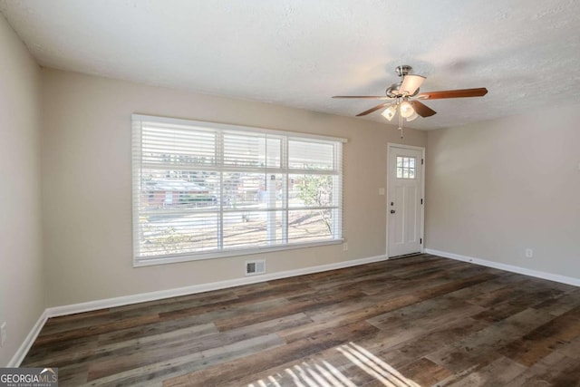 interior space featuring a textured ceiling, dark hardwood / wood-style floors, plenty of natural light, and ceiling fan