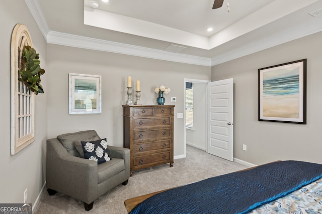 carpeted bedroom with a tray ceiling, ceiling fan, and ornamental molding