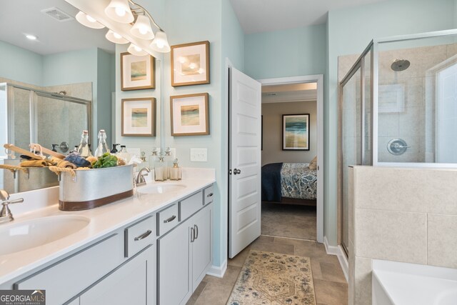 bathroom featuring tile patterned flooring, vanity, and separate shower and tub