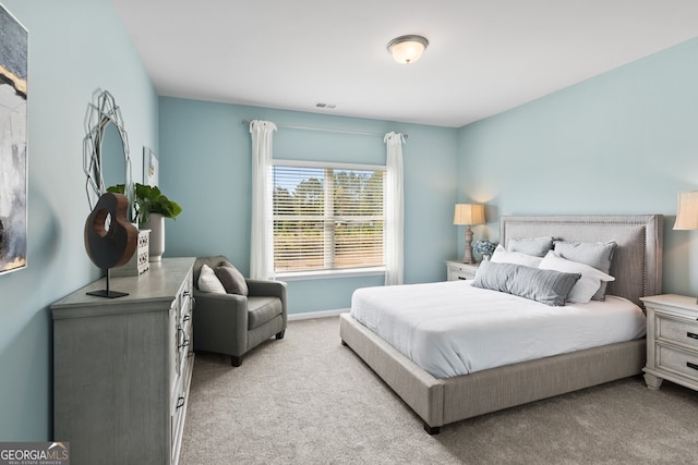 bedroom featuring light colored carpet