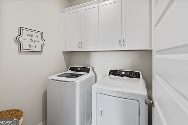 washroom with cabinets and separate washer and dryer