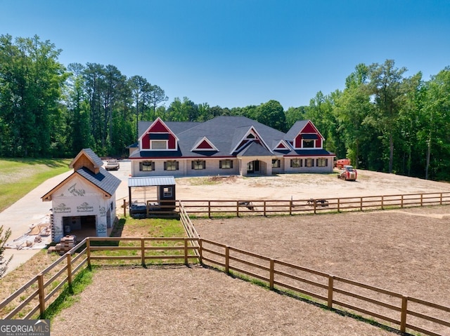 view of front of property featuring a rural view and an outdoor structure