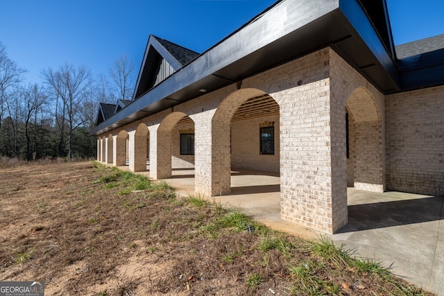 view of side of home with a patio area