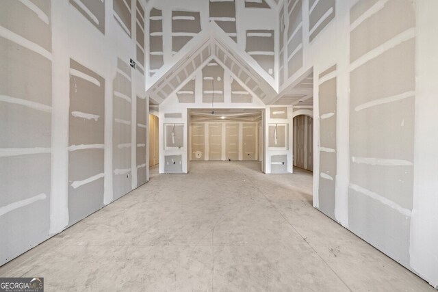 unfurnished living room with a high ceiling