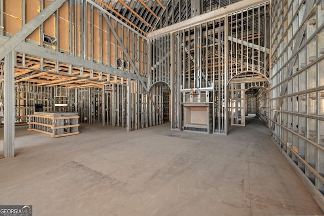 miscellaneous room with a towering ceiling