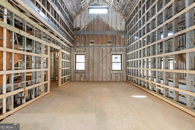 misc room featuring a healthy amount of sunlight and high vaulted ceiling