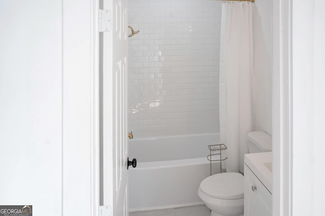 bathroom featuring vanity, shower / bath combo with shower curtain, and toilet