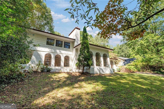 mediterranean / spanish home with a front lawn