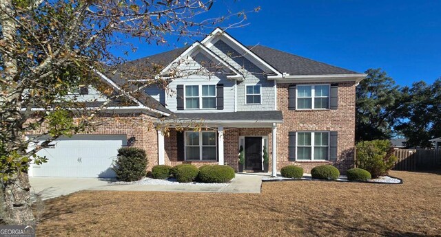 view of front of house featuring a garage and a front lawn