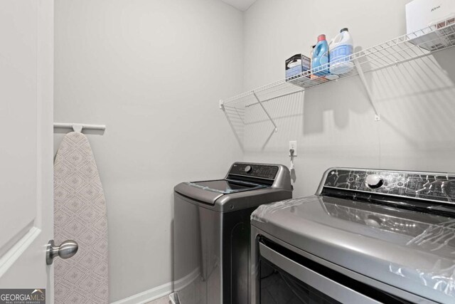 clothes washing area with separate washer and dryer