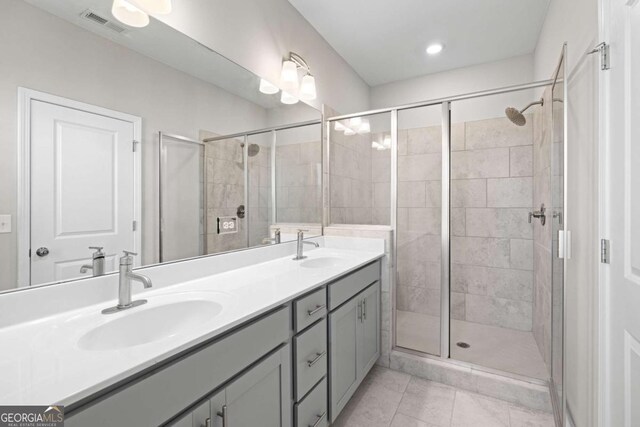 bathroom featuring tile patterned floors, vanity, and an enclosed shower