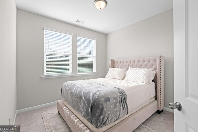 bedroom featuring light carpet