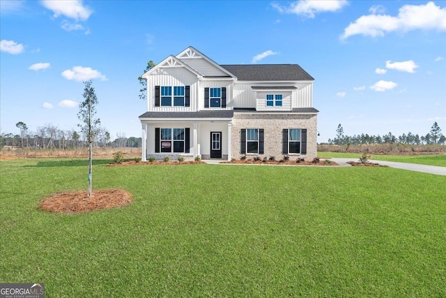 view of front of property featuring board and batten siding and a front yard