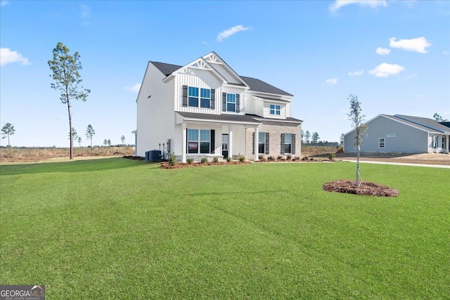 view of front of property featuring central air condition unit, board and batten siding, and a front yard