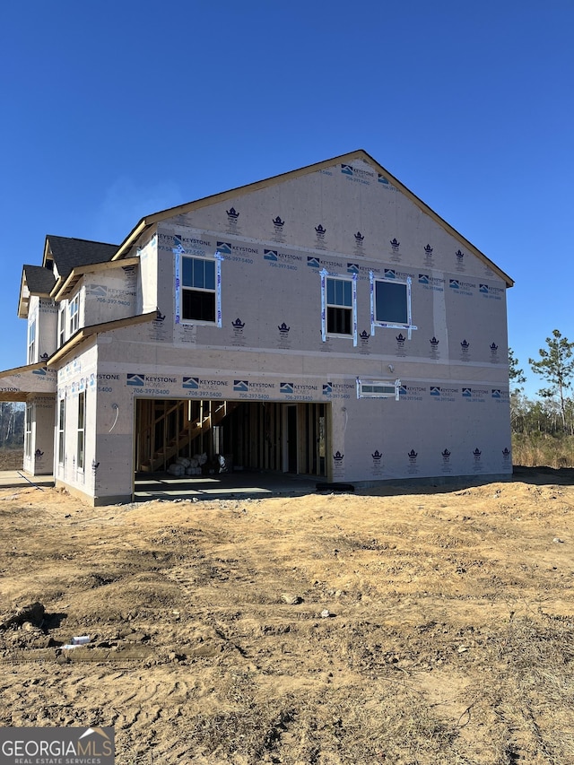 back of house featuring a garage