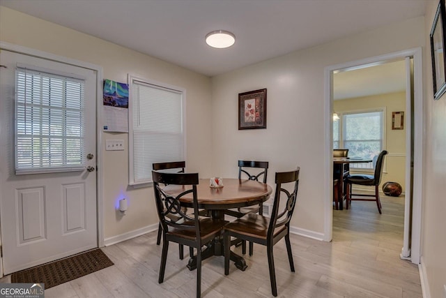 dining room featuring light wood-type flooring and plenty of natural light