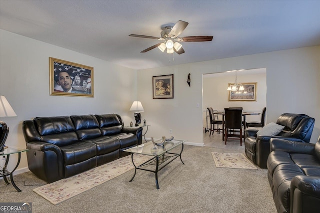 living room with carpet and ceiling fan with notable chandelier