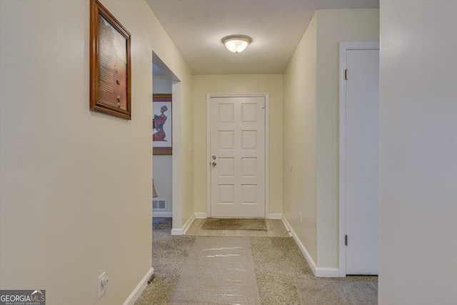 corridor featuring light carpet