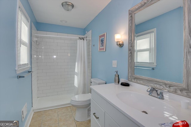 bathroom featuring tile patterned flooring, vanity, a shower with shower curtain, and toilet