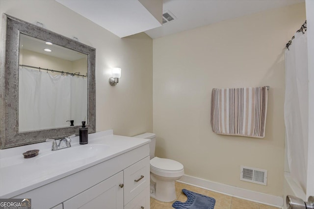 bathroom featuring tile patterned floors, vanity, and toilet