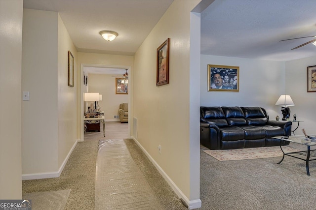 hallway featuring light carpet