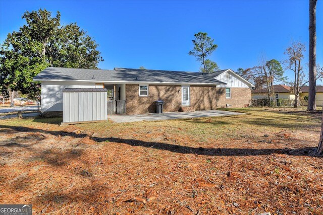 back of house with a lawn