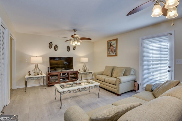 living room with ceiling fan and light wood-type flooring