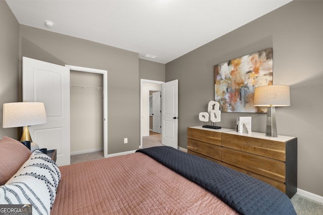 bedroom featuring a closet and light colored carpet