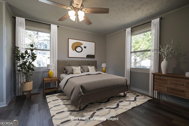 bedroom with a textured ceiling, ceiling fan, and dark hardwood / wood-style floors