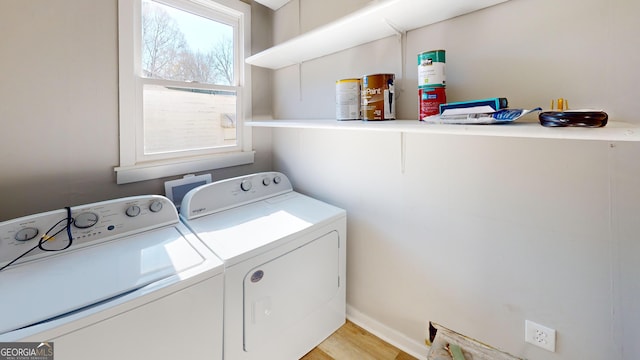 washroom with independent washer and dryer and light hardwood / wood-style flooring