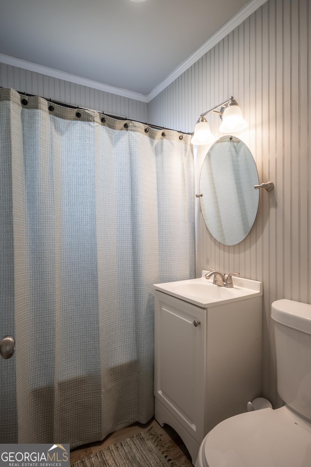 bathroom featuring vanity, toilet, and ornamental molding