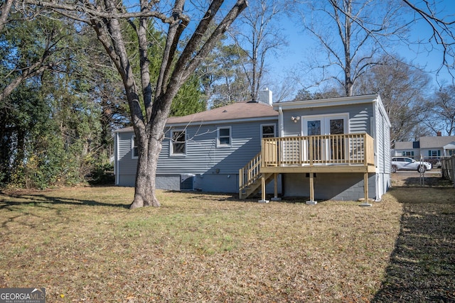 rear view of house featuring central AC unit, a lawn, and a wooden deck