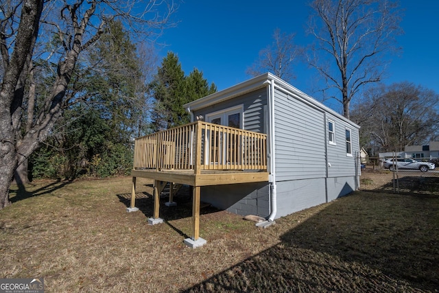 view of home's exterior with a yard and a deck