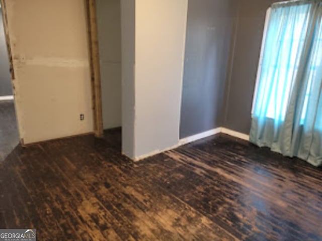 unfurnished bedroom featuring dark hardwood / wood-style flooring