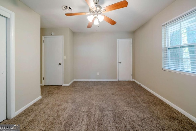 interior space featuring ceiling fan and carpet