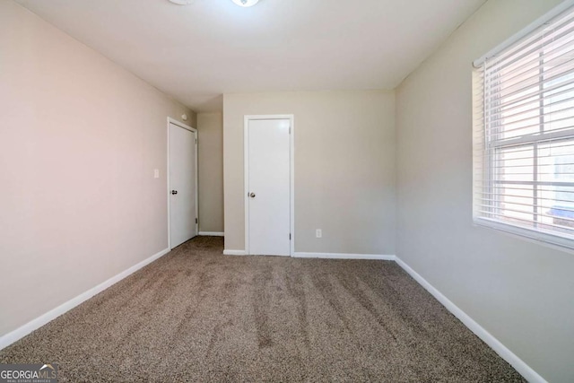 unfurnished bedroom with carpet and multiple windows